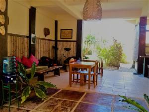a living room with a couch and a table at Batu Ampar Menjangan in Banyuwedang
