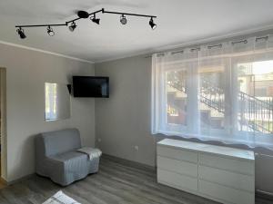 a living room with a window and a chair at Relax in Ostrowo