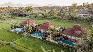 an aerial view of a villa in a rice field at Airsania Ubud Antique Villas in Ubud