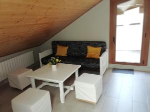 a living room with a couch and a table at Casa del Sol in Organyà