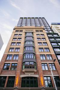 a tall brick building with many windows at Ace Hotel Sydney in Sydney