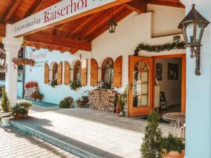 a building with a sign for a restaurant at Kaiserhof in Reit im Winkl