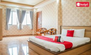 a bedroom with a bed with red and white pillows at Bich Thu Hotel in Ho Chi Minh City