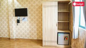 a living room with a tv and a book shelf at Bich Thu Hotel in Ho Chi Minh City +25 photos