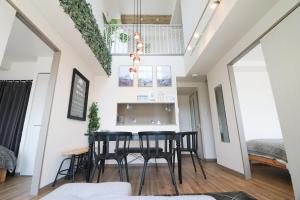 a dining room with black chairs and a table at SERENAR Minami 13 Jo 903 in Sapporo