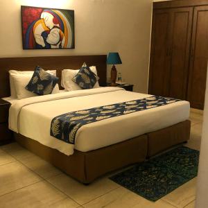 a bedroom with a large bed in a room at The Neem in New Delhi