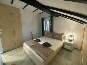 a bedroom with a large bed and a window at Apartmani Grebastica in Grebaštica +67 photos