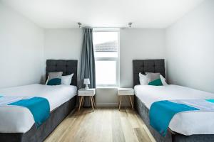 Säng eller sängar i ett rum på OYO Studiotel GY - Modern Hotel Apartments