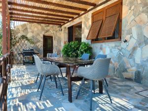 a wooden table and chairs on a patio at Casa del Duca Portoferraio in Portoferraio
