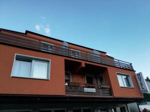 an orange building with a balcony on it at Hotel Zur Rose in Bad Karlshafen