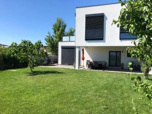 dom z trawnikiem przed nim w obiekcie das Haus in Jois w mieście Jois