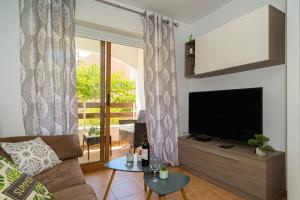 a living room with a couch and a flat screen tv at Apartment E041 Albir in Alicante