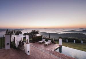 a villa with a pool and a view of the mountains at Casa Vesta in Zufre