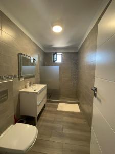 a bathroom with a toilet and a sink and a shower at LS Lake Apartment Mamaia Nord in Mamaia Sat/Năvodari