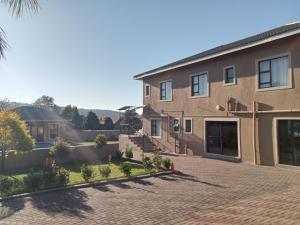 a brick driveway in front of a house at La Bronze Guest Lodge in Newcastle