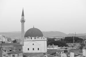 a black and white photo of a mosque with a minaret at The Efendi Hotel Akko in Acre