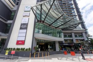 a large building with a glass facade with orange signs at Le Vert Boutique Hotel in Genting Highlands