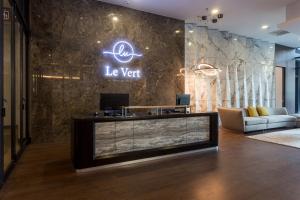 a lobby with a reception desk and a sign on a wall at Le Vert Boutique Hotel in Genting Highlands