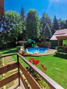 a backyard with a swimming pool and a fence at Вила Край реката in Botevgrad +74 photos