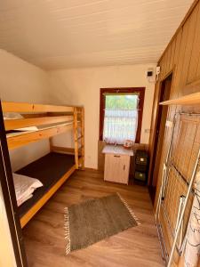 a room with two bunk beds and a window at Słowińska Natura in Smołdziński Las