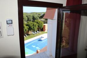 a door with a view of a swimming pool at Hostal Alhambra in Zahora