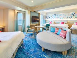 a hotel room with two beds and a couch at Grand Nikko Tokyo Bay Maihama in Urayasu