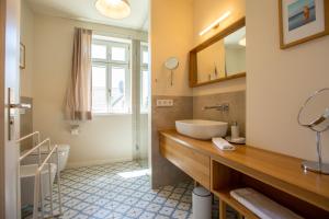 a bathroom with a sink and a mirror at Kapitänshaus Luv & Lee in Wustrow +34 photos