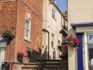 a brick building with flower boxes on the side of it at Fonaby in Market Rasen