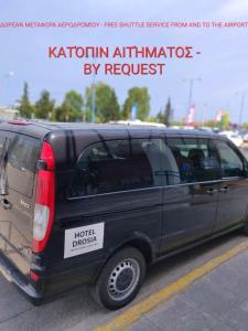 a black van parked in a parking lot at Hotel Drosia in Messini