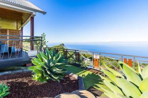 a house with a balcony with a view of the ocean at Kaz Noulafé in Saint-Leu