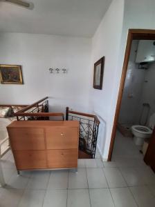 La salle de bains est pourvue d'une commode en bois et de toilettes. dans l'établissement Holiday Home in Sarti, Chalkidiki, à Sarti