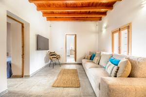 a living room with a couch and a tv at Villa Can Rafalet in Sant Josep de sa Talaia
