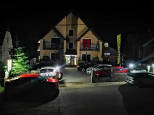 a group of cars parked in a parking lot at night at Gorska Vila Apartments in Žabljak