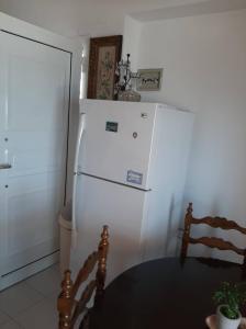 - un réfrigérateur blanc dans la cuisine avec une table dans l'établissement Holiday Home in Sarti, Chalkidiki, à Sarti
