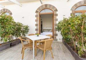 a table and chairs on a patio with plants at Complesso San Francesco in Massa Lubrense