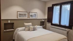 a bedroom with two beds and a tv at La Quintana de Figares in Luarca