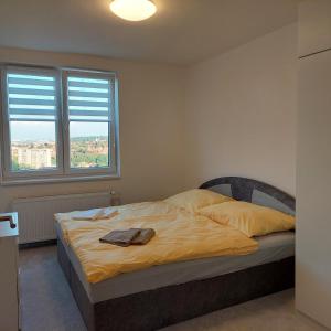 a bedroom with a bed with a towel on it at View of Prague in Prague