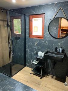 a bathroom with a shower and a sink and a mirror at Chata TRI GROŠE 3 in Námestovo +28 photos
