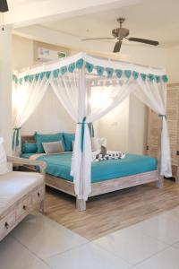 a bedroom with a bed with a canopy at Luz_ita Sunshine Villa in Uluwatu