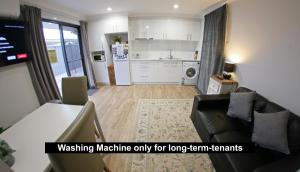 a living room with a couch and a kitchen at Granny Flat next to golf course in Stanthorpe