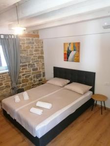 a bedroom with a bed with two towels on it at GG art apartments II in Piran