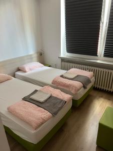 a bedroom with two beds with towels on them at Waffel Cafe HOSTEL Monteurwohnung Ferienwohnung in Kassel +8 photos
