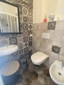 a bathroom with a toilet and a sink at Christy House in Vignale