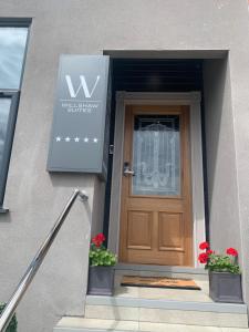 a entrance to a building with a wooden door at Willshaw Suites for families over 25 only in Blackpool