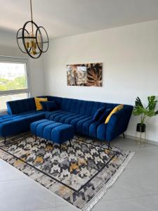 a blue couch in a living room with a rug at Rothschild Royal in Ashdod