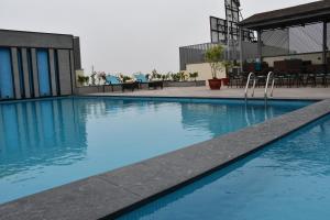 a swimming pool with blue water in a building at Cygnett Park BL in Jaipur