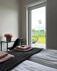 a bedroom with a bed and a sliding glass door at Domy na polanie- Szarotka in Wolany