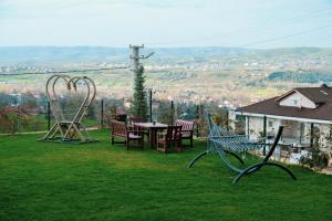 a garden with a table and chairs and a roller coaster at Kartepe LOFT in Kartepe