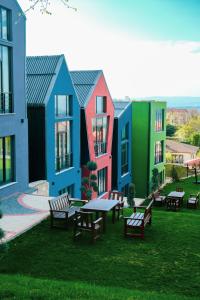 a group of buildings with tables and benches in the grass at Kartepe LOFT in Kartepe