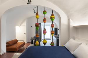 a bedroom with a blue bed with colorful lamps at BLU - Apulian Suite in Bari